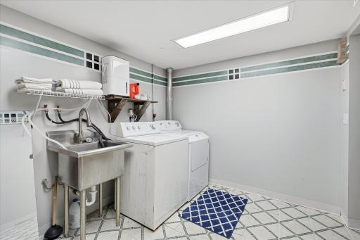 Laundry room highlights the convenient utility sink, generous floor space, and room for additional storage or organization.