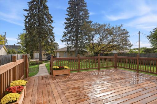 Spacious New wood deck overlooking the beautiful backyard, offering plenty of room for grilling, outdoor dining, entertaining, and relaxing.