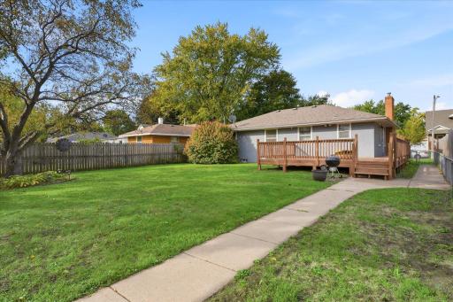 Beautiful, fully fenced backyard featuring an abundance of established fruit trees and plants, including a Honeycrisp apple tree, cherry tree, huckleberry tree, blackberry and raspberry bushes, and rhubarb.