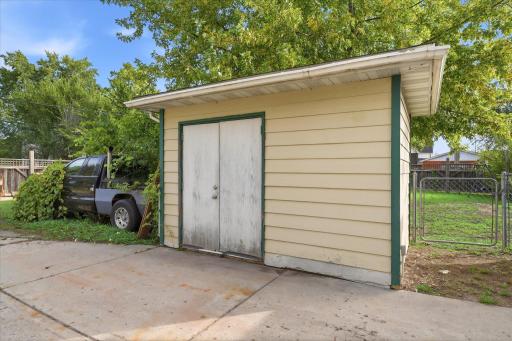 Convenient detached storage shed has electricity and provides additional space for lawn equipment, gardening supplies, tools, and seasonal storage.