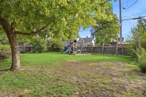 Spacious .37 acre yard with mature shade trees, green space, and a large playset (can stay or go). Plenty of room to enjoy outdoor activities.