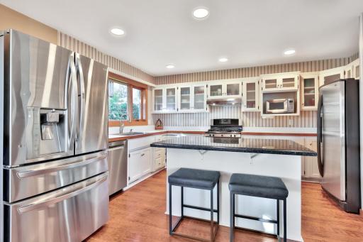 Updated kitchen with center island and stainless appliances.