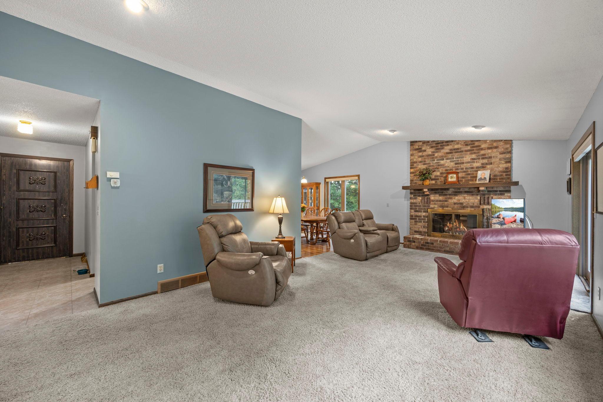 Vaulted ceiling with a wood fireplace.
