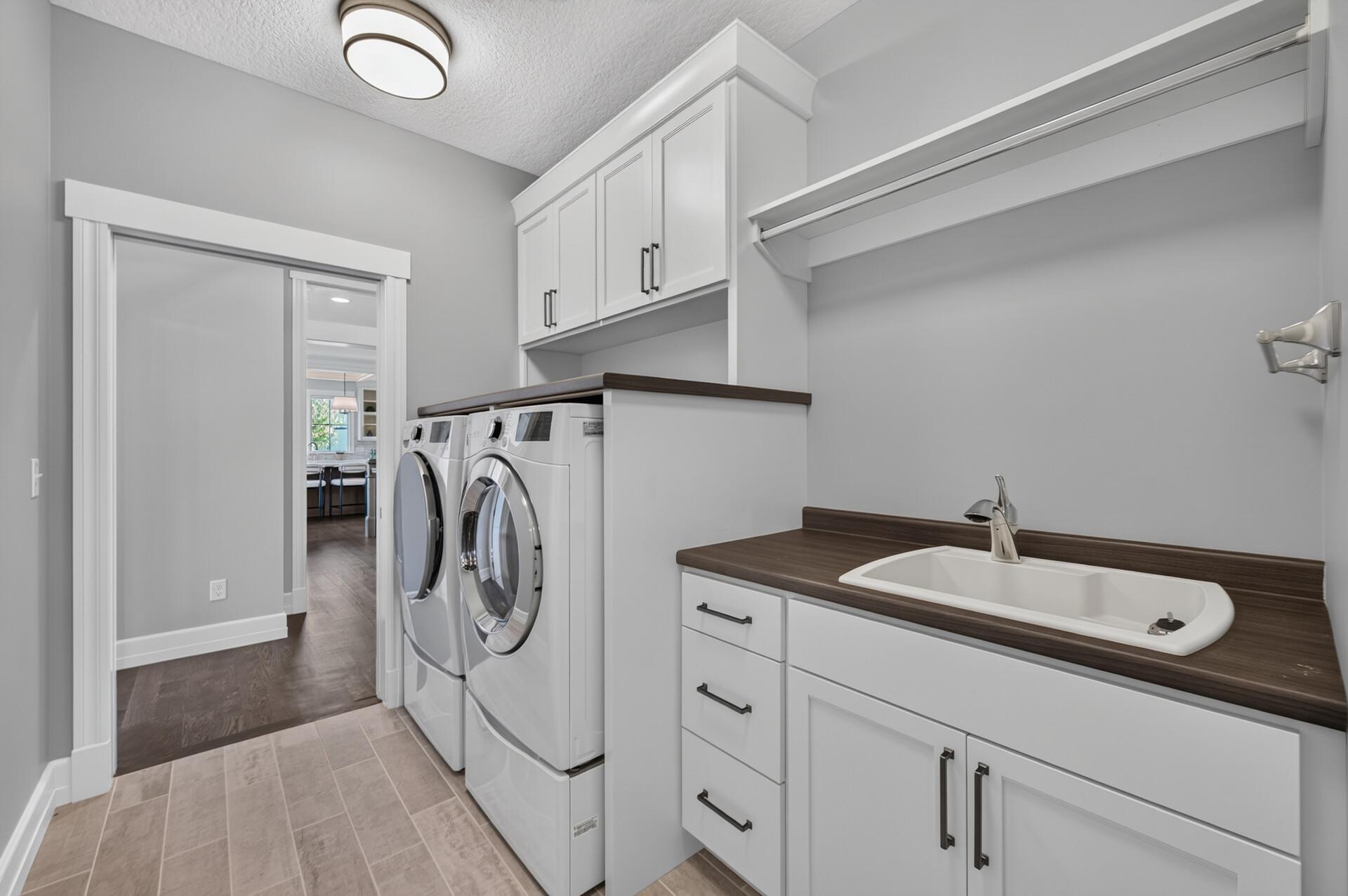 Main Level Laundry Room connects directly to the Owner's Suite Walk-in Closet for added convenience