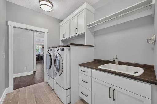 Main Level Laundry Room connects directly to the Owner's Suite Walk-in Closet for added convenience