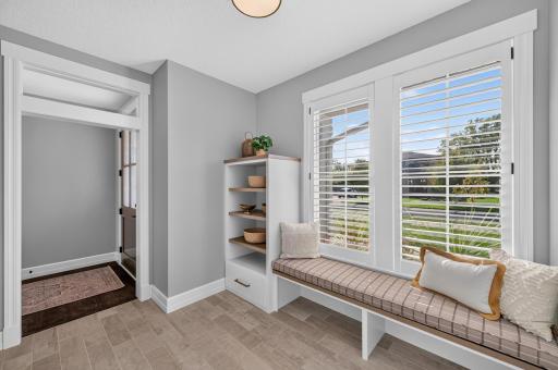 Spacious Mudroom includes built-ins, bench with shoe storage, and a large walk-in closet