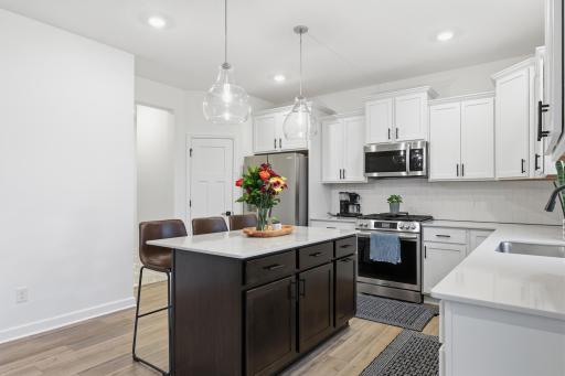Stunning chefâs kitchen featuring quartz countertops, stainless steel appliances, a large center island, and abundant cabinetry for effortless entertaining.