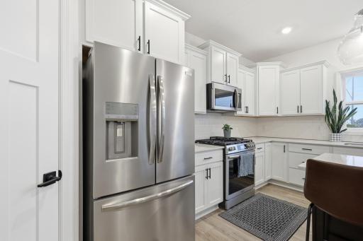 Bright and beautifully designed kitchen with a spacious island, modern finishes, and an open layout perfect for gathering.