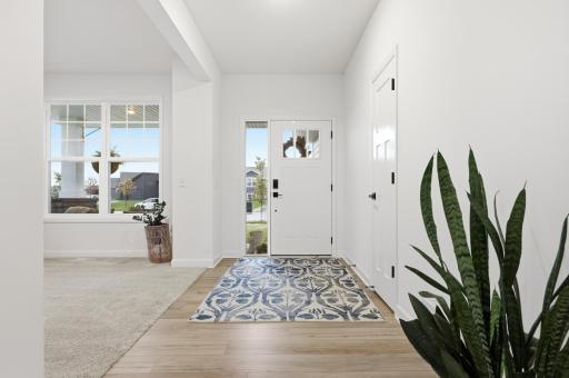Welcoming main entrance featuring an open foyer, abundant natural light, and convenient storage for everyday living.