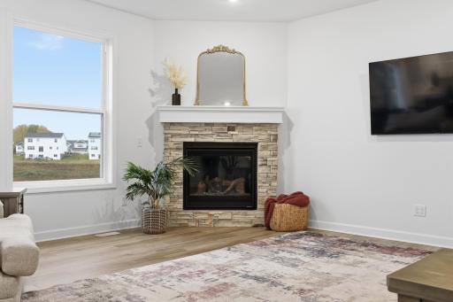 Enjoy cozy evenings by the fireplace while taking in picturesque views from this light-filled living room.