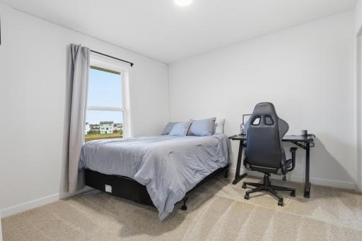 Light-filled bedroom offering a clean, modern feel and plenty of space to make your own.