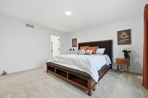A peaceful primary retreat featuring a private ensuite bathroom, walk-in closet, and abundant natural light.