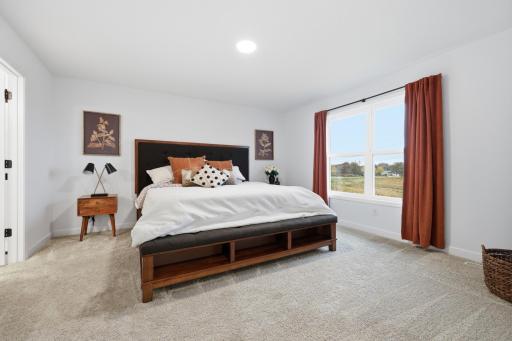 Spacious primary suite featuring a private bath and walk-in closet, creating the perfect retreat at the end of the day.