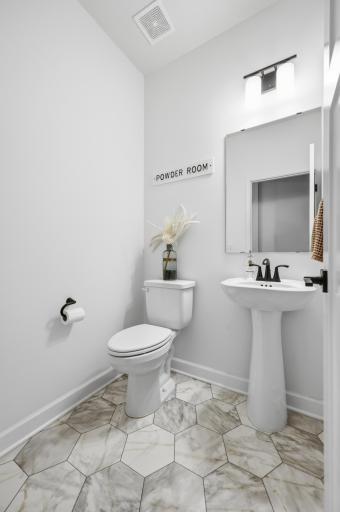 tylish main-level powder room with modern finishes and a fresh, contemporary design.