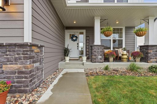 Welcoming covered front porch with charming stone accents, creating the perfect place to relax and enjoy the neighborhood.