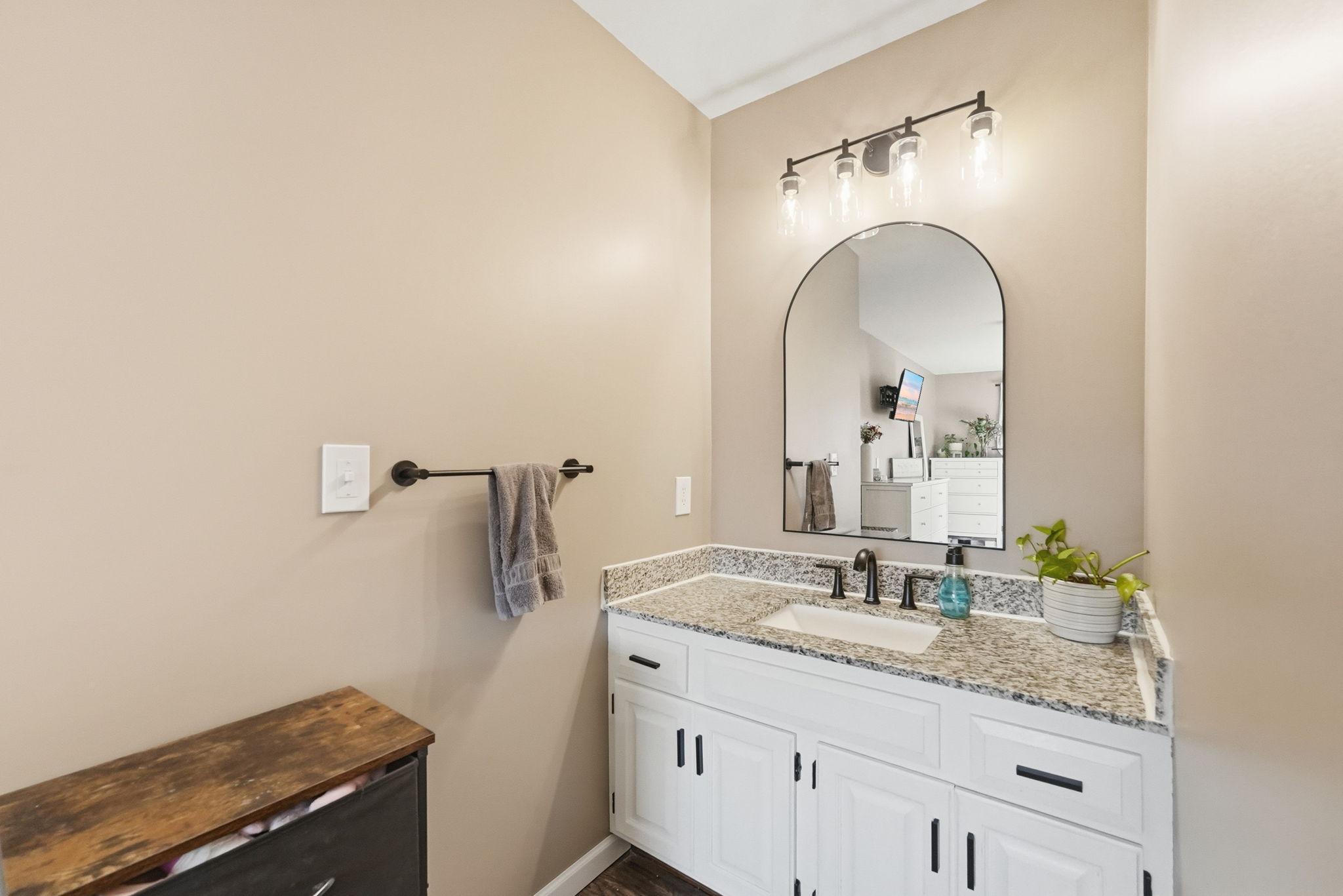 Granite vanity with modern lighting