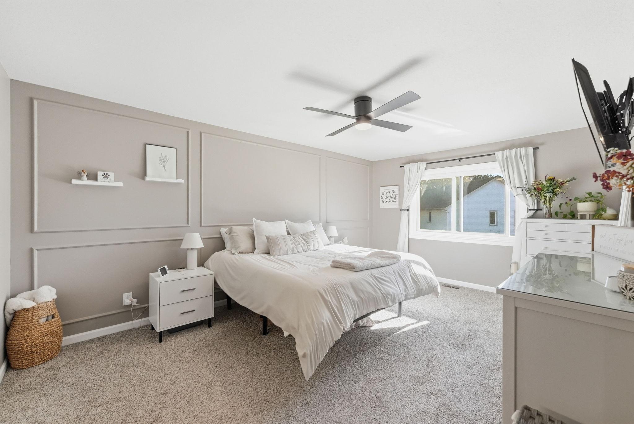 Spacious master bedroom with accent wall