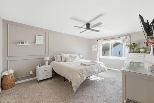 Spacious master bedroom with accent wall & new fan, windows, and private bathroom access