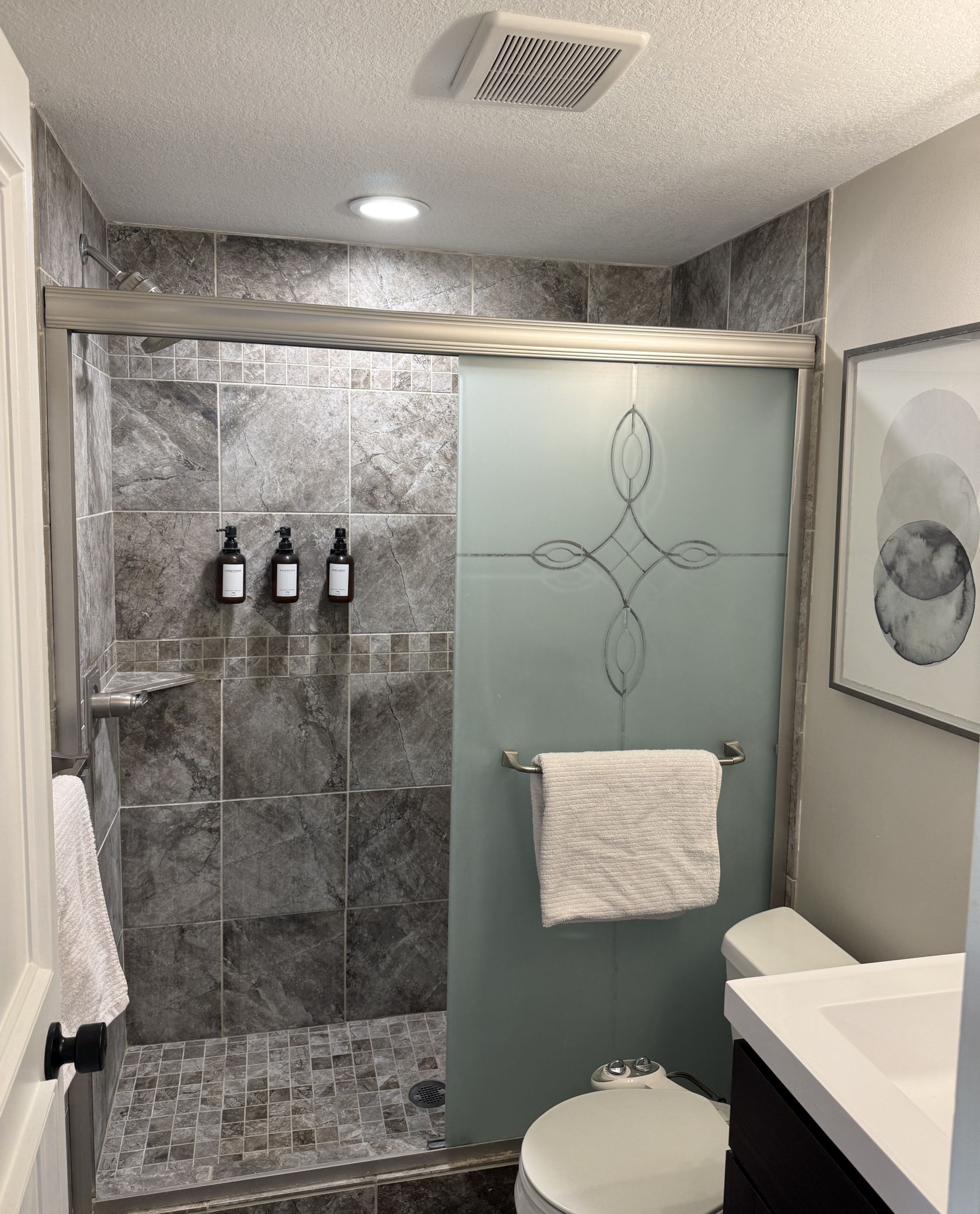 Custom tiled shower with mosaic accents