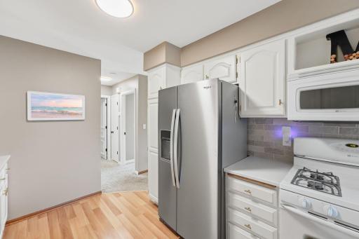 Professionally refinished cabinets, matching hardware, pull out cutting board, and huge stainless fridge