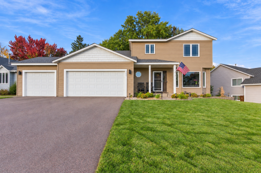 Bright Suburban Home with Empty Driveway.png