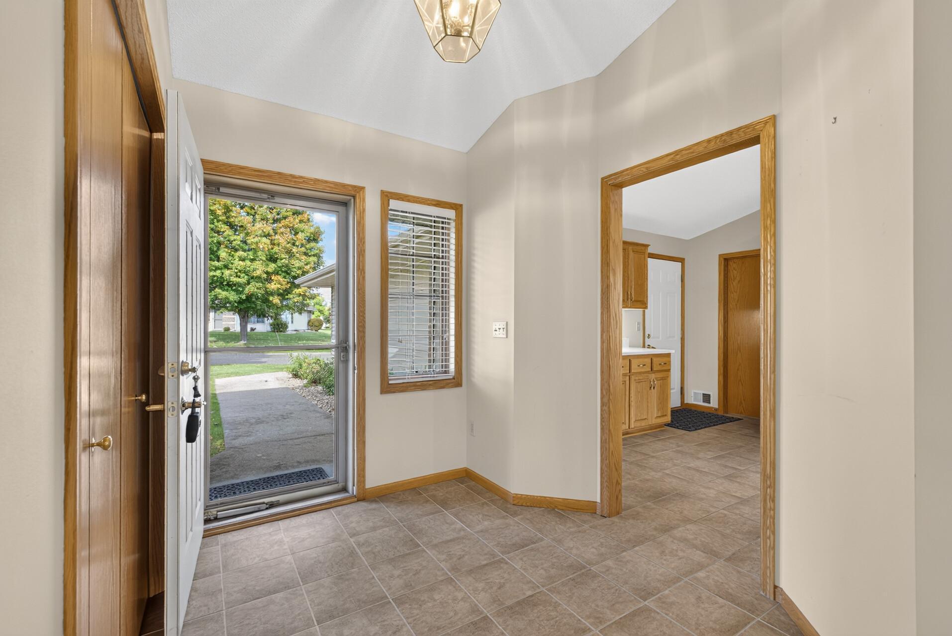 Foyer with large closet and easy care tile floors.