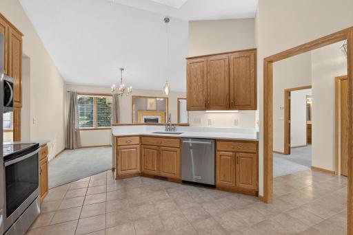 Updated Kitchen with sleek Corian countertops, stainless appliances and custom cabinetry.