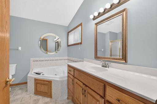 Relaxing whirlpool tub and oversized vanity which provides plenty of counter top space and storage as well.