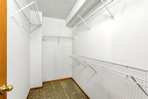 Spacious, organized walk-in closet offering ample storage and a clean, functional layout within the primary bedroom.