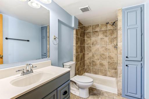 Updated lower-level 3/4 bath offering fresh finishes, great function, and convenient access near the bedrooms.