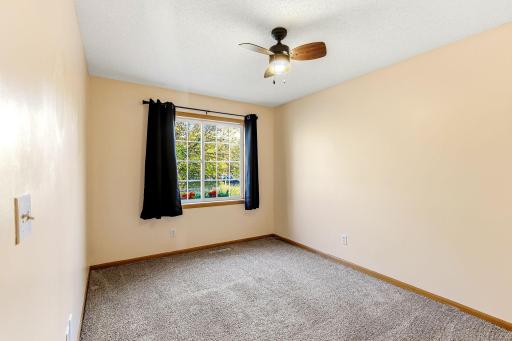 Bright, flexible upper-level bedroom currently styled as a productive home office, offering comfort, privacy, and versatile use.