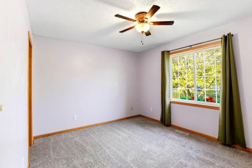 Expansive window that fills the room with natural light, highlighting the primary's bright, airy feel.