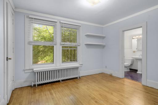 Main floor bedroom with hardwood floors and ample closet space