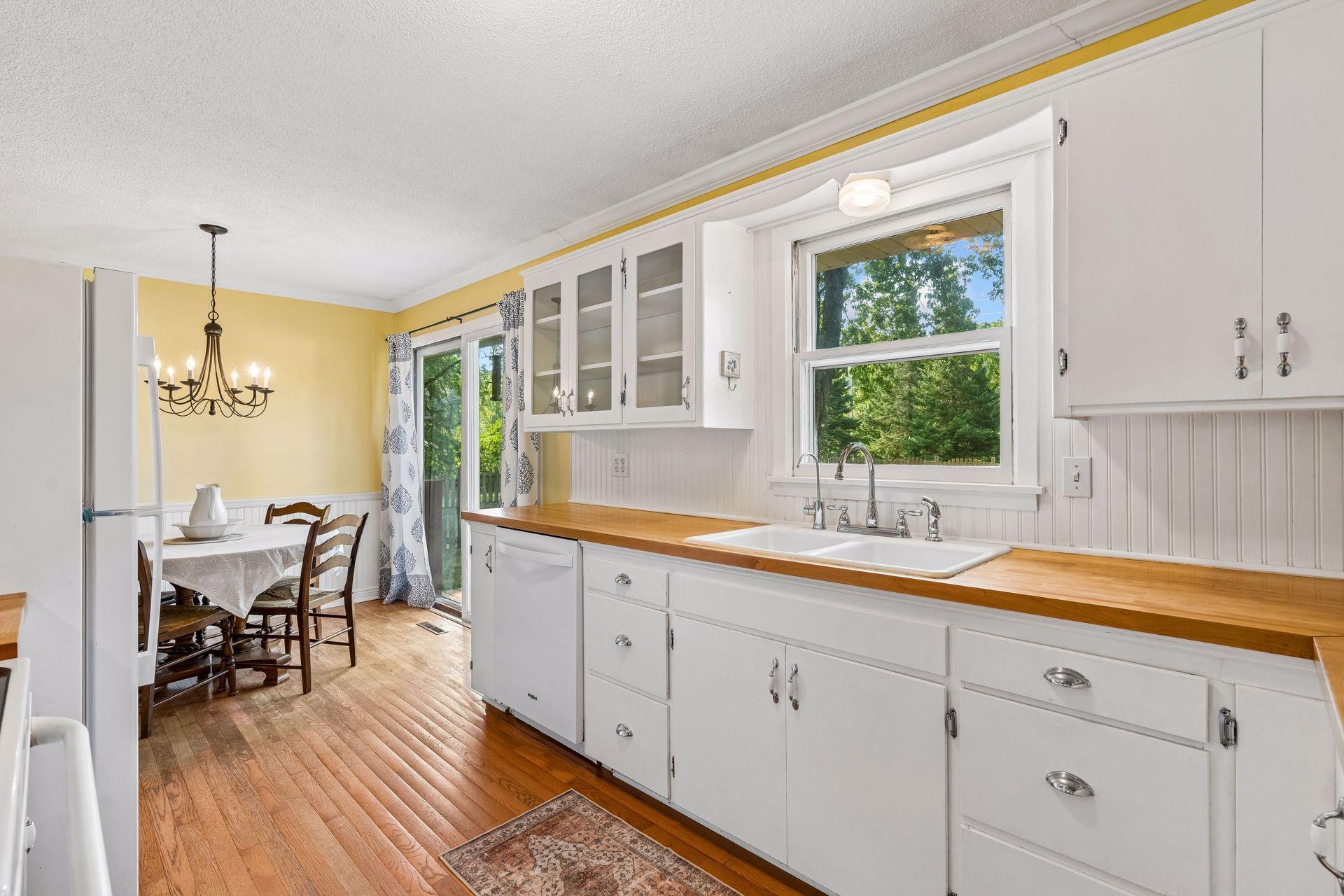 Butcher Board countertops compliment the white cabinetry