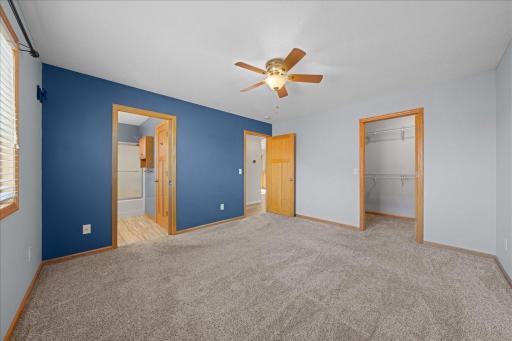 Another view of the primary suite towards the private bathroom and walk in closet.