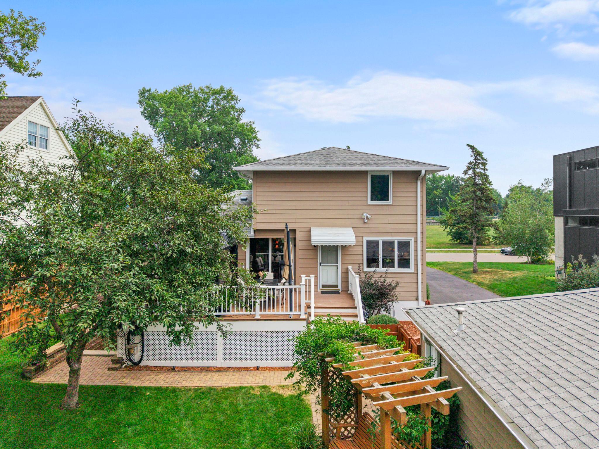 This angle highlights the home's classic architecture and mature landscaping from the back corner of the lot.
