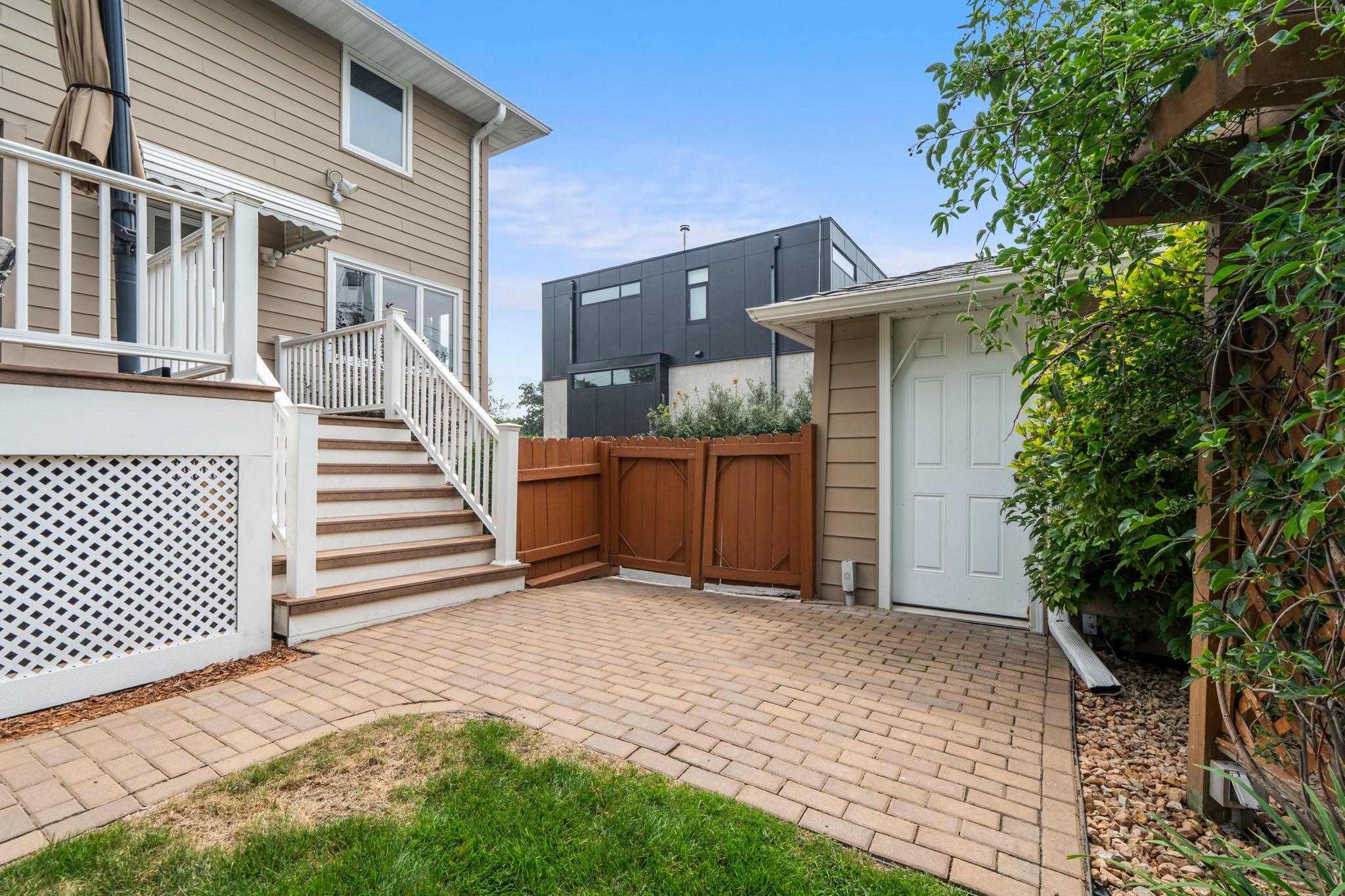 A private walkout door and paver patio give the lower level separate access, ideal for guests or in-law living.