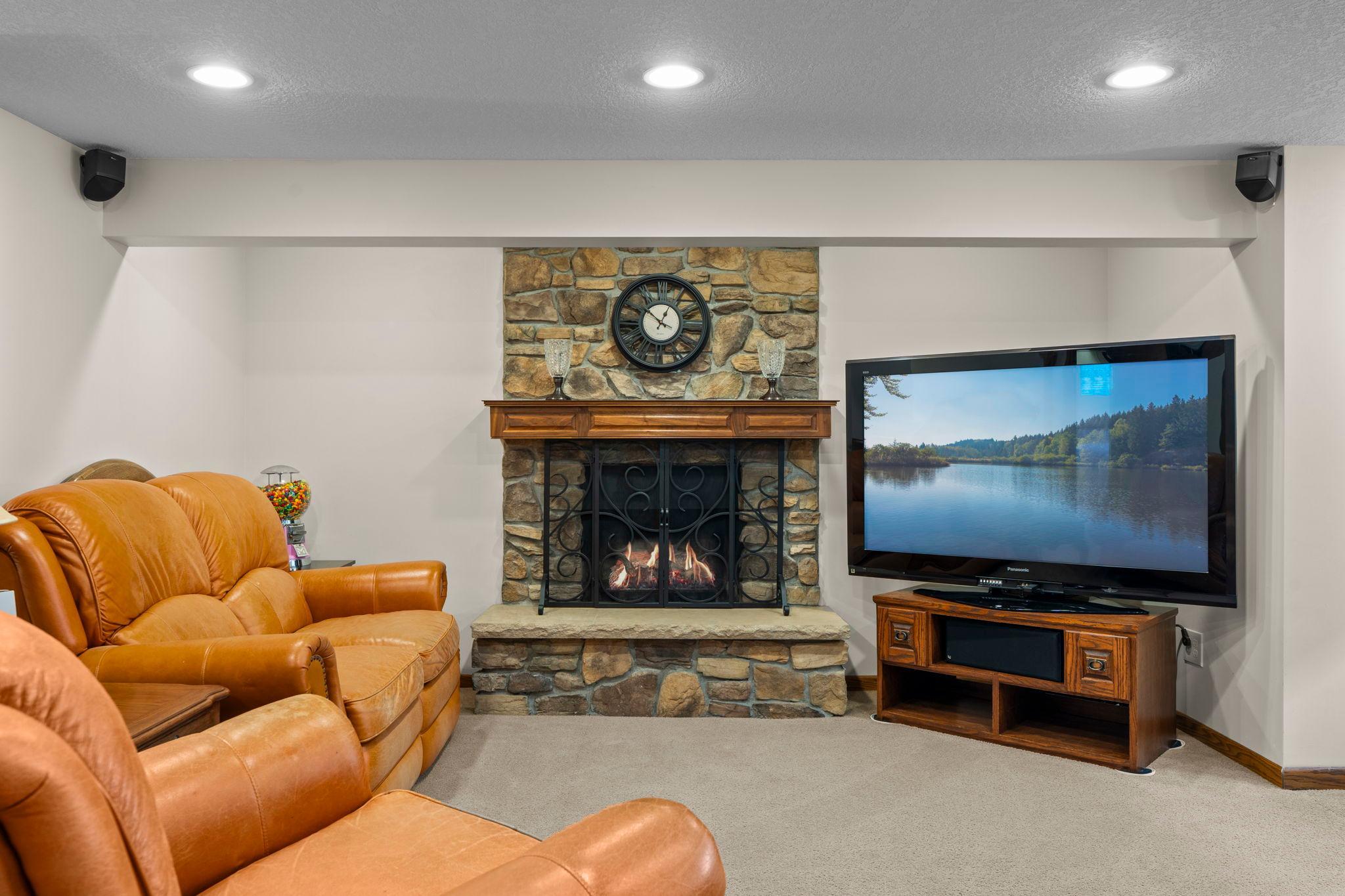 The walkout lower level's family room features a stone fireplace, the third in the home, and plenty of room to gather.