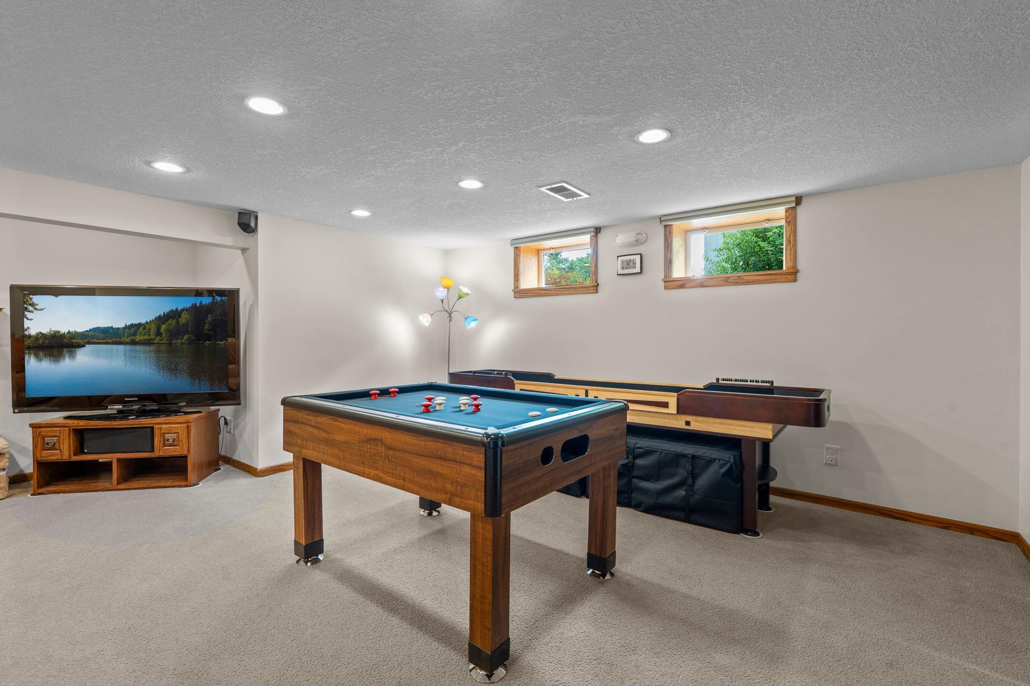 The lower level also includes a game room with space for a pool table and shuffleboard, perfect for entertaining.