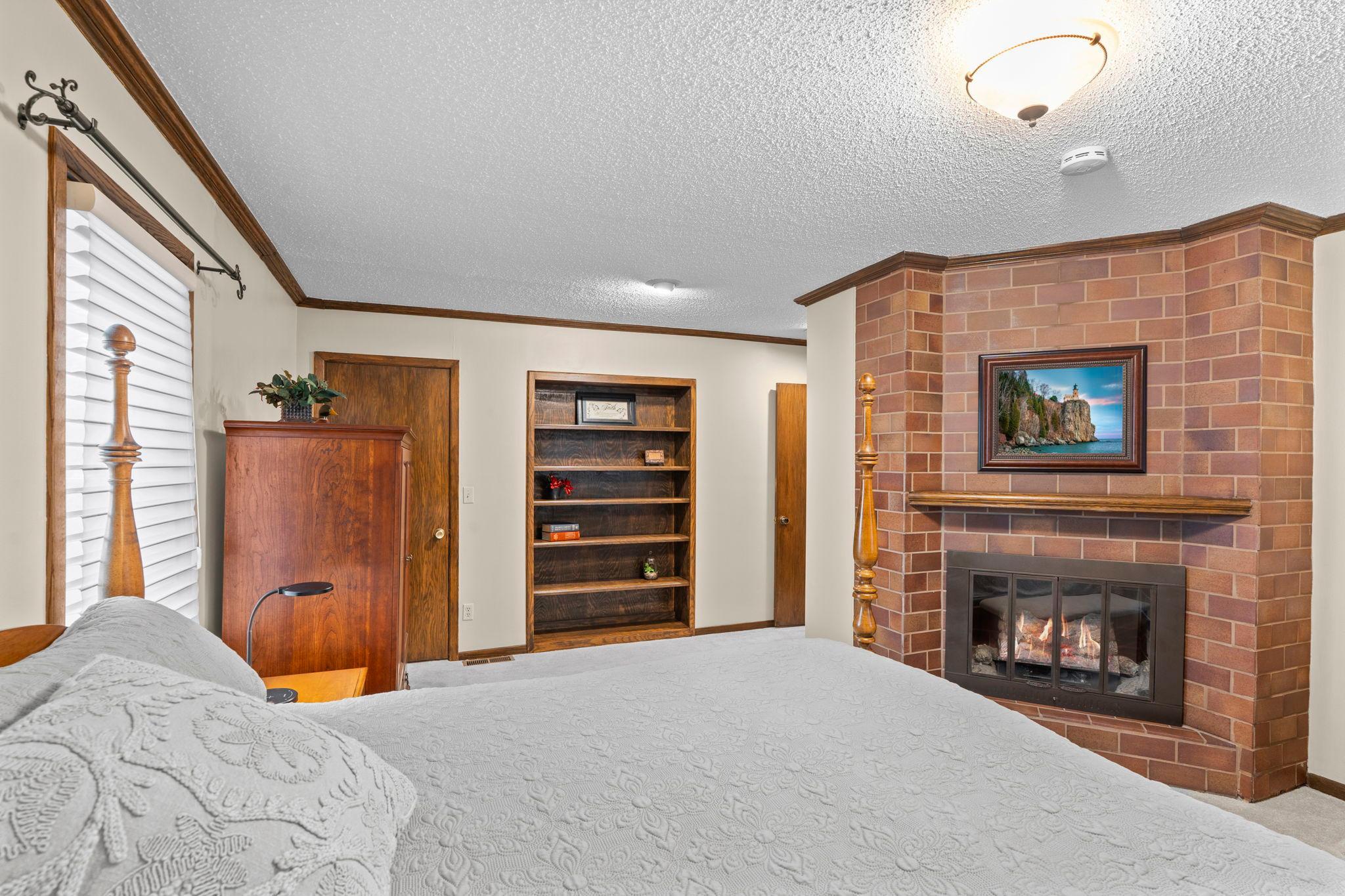 Built-in shelving and a private electric fireplace make this a true primary suite retreat.