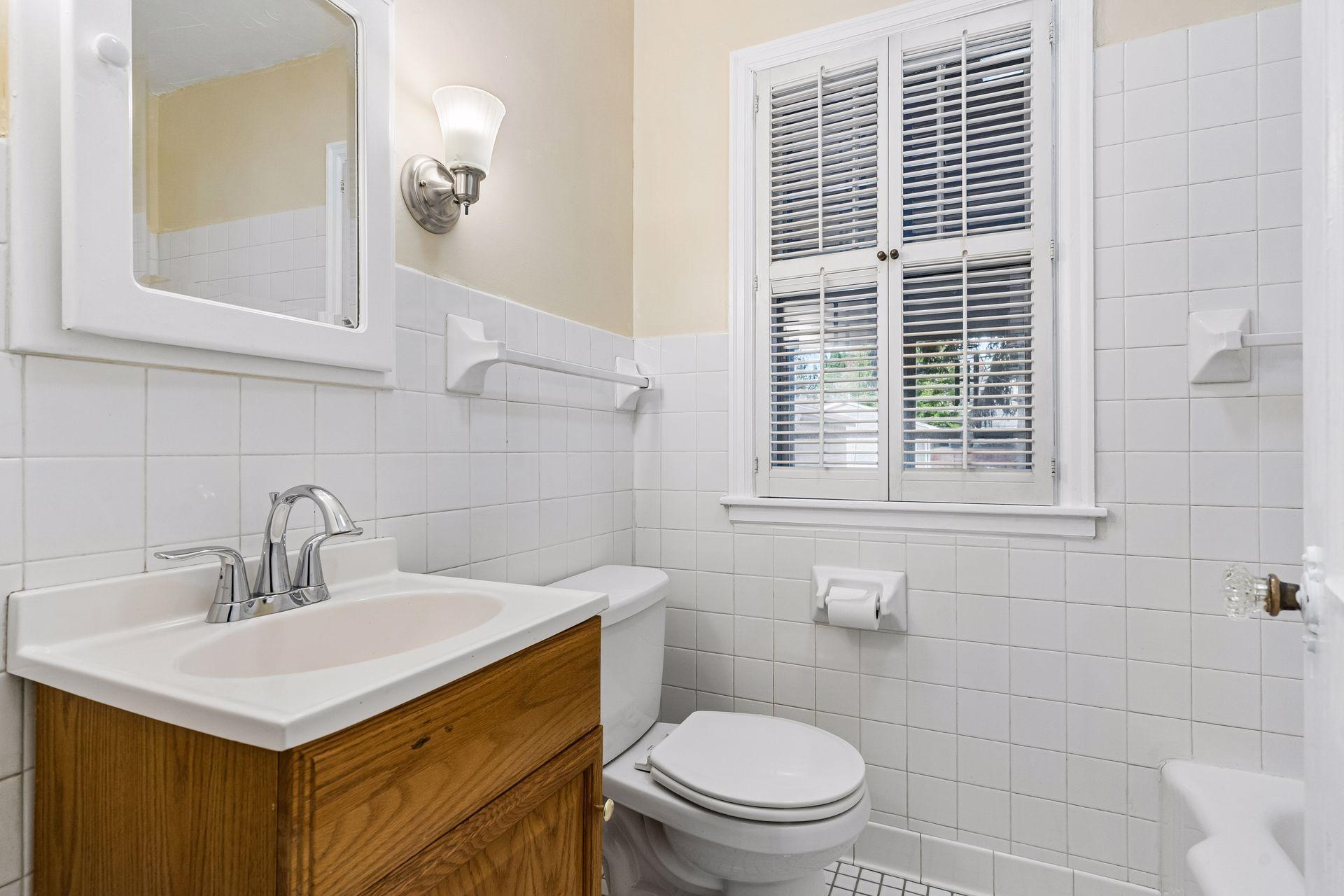 A full bath is right around the corner from the bedroom. There is a deep linen closet at the end of the hallway.