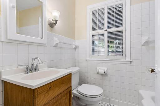 A full bath is right around the corner from the bedroom. There is a deep linen closet at the end of the hallway.