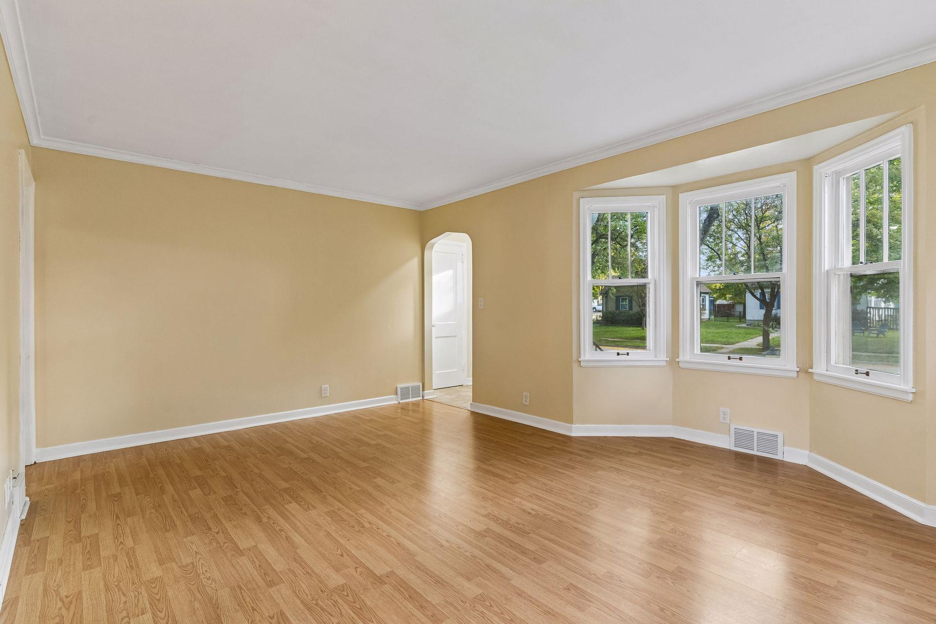 The living room has a large bay window which lets in plenty of sunlight.