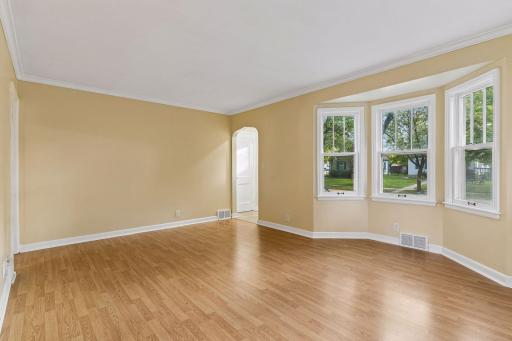 The living room has a large bay window which lets in plenty of sunlight.