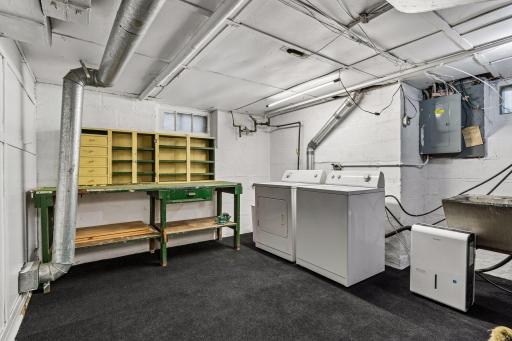 This capacious laundry room has plenty of space for a workshop.