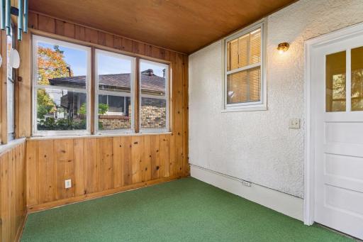 The three-season porch is just off the landing between the kitchen and the basement stairs.
