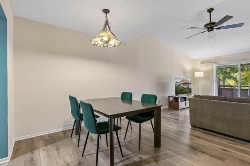 Open living and dining area with vaulted ceilings and luxury vinyl flooring throughout main living areas. Open living and dining area with vaulted ceilings and luxury vinyl flooring throughout.