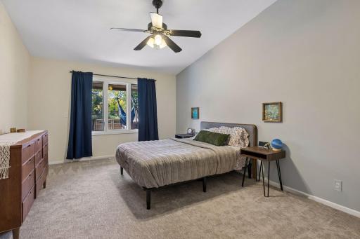 Spacious primary bedroom with vaulted ceiling.