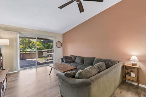 Spacious living room with vaulted ceilings, golf course views and direct deck access.