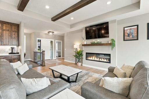 Family Room w/ wood ceiling beams & beautiful custom fireplace